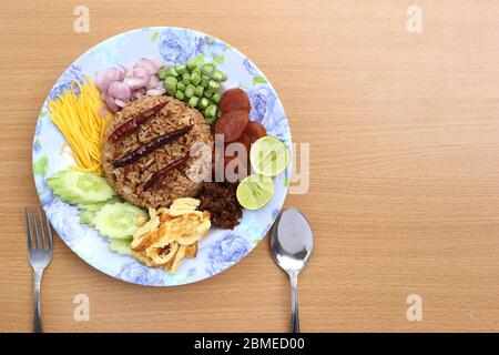 Vista dall'alto. Riso misto con pasta di gamberi composta da maiale dolce, salsiccia cinese, uova fritte, fette di cetriolo, mango agrodolce, scalogno, fagiolo lungo, roa Foto Stock