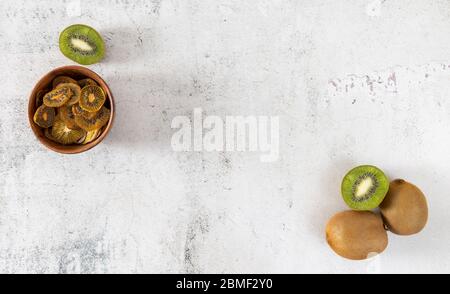 Patatine di frutta. Fette di kiwi essiccate su una superficie leggera Foto Stock