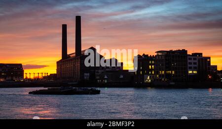 Cielo rosso al tramonto a ovest di Londra, con i camini di lotti Road Power Station stagliano accanto al Fiume Tamigi. Foto Stock