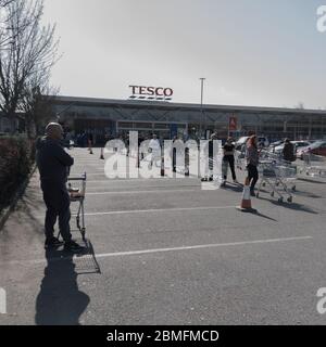 Tesco, Clowne, Chesterfield / Regno Unito - Marzo 26 2020 persone in fila per fare le settimane di shopping nel Regno Unito questo è a metà settimana all'inizio del Foto Stock