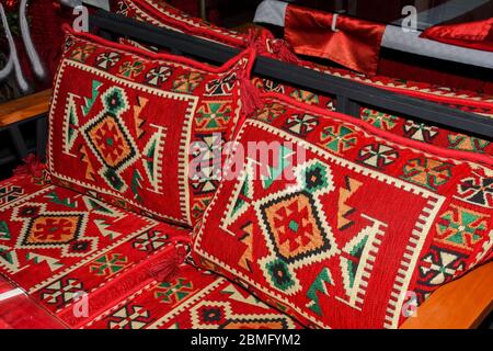 Pile colorate di cuscini orientali con motivi decorativi. Foto Stock