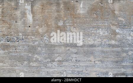 Struttura di parete in cemento vecchio e intemperie. Intonacatura è parzialmente sbucciata. Sfondo astratto ad alta risoluzione con texture full frame. Foto Stock