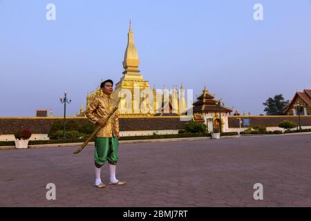 Ritratto di bel giovane felice vestito in tradizionale etnia Lao Abbigliamento di fronte a Pha che Luang Grande Stupa nel Vientiane Laos City Center Foto Stock