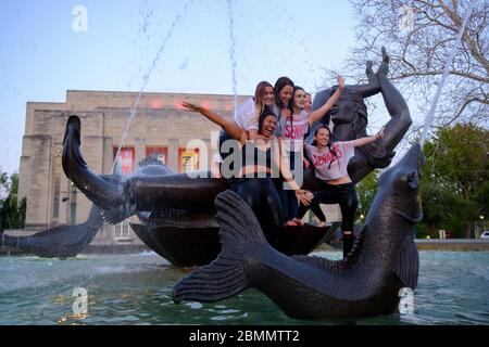 Bloomington, Stati Uniti. 9 maggio 2020. Un gruppo di studenti dell'Indiana University che hanno appena terminato di laurearsi alla Kelley School of Business durante una video cerimonia questo fine settimana festeggia dopo saltando nelle acque della Show-Alter Fountain e posando per photographs.Lezioni a IU sono stati insegnati virtualmente dalla pausa primaverile a causa della pandemia COVID-19/Coronavirus, e le lezioni di persona sono state annullate e la cerimonia di laurea annuale di persona è stata annullata. Credit: SOPA Images Limited/Alamy Live News Foto Stock