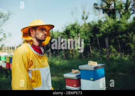 Ritratto di un giovane apicoltore nel suo apiario Foto Stock