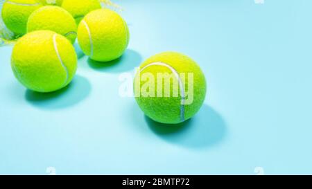 Le palle da tennis si chiudono sul campo da tennis blu duro. Spazio di copia, messa a fuoco selettiva. Blu e giallo. Foto Stock