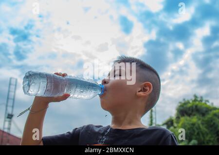 I ragazzi bevono acqua fredda. Foto Stock