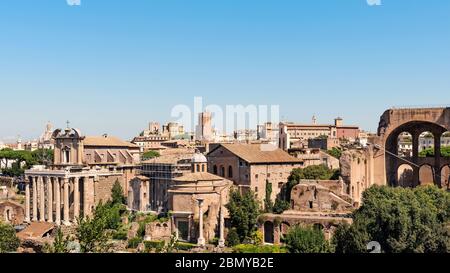 Vista sul Tempio di Antonino e Faustina e sul tempio di Romolo di fronte e sulla città di Roma, vista dal Foro Romano, Roma, Italia Foto Stock