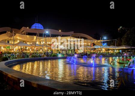 Vista notturna dell'edificio del Casino' e del centro ricreativo multifunzionale situato nel Parco di Rinia nel centro citta' di Tirana. Albania. Foto Stock