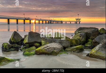 Alba spettacolare con nuvole colorate sul ponte sul mare di Burgas. Simbolo della sità. Foto Stock