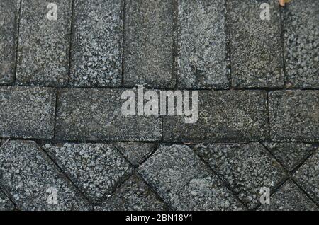 Pavimentazione pietra texture. Tessitura della piastrella pavimentata sul fondo della strada. Foto Stock