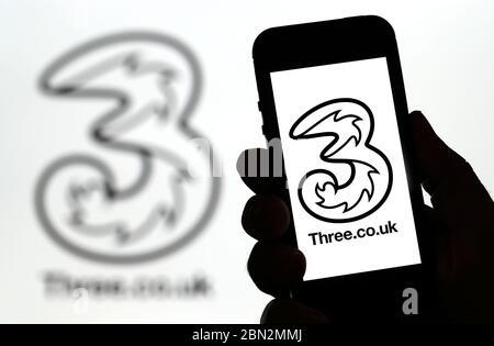Tre logo della rete di telefonia mobile su un telefono cellulare (solo per uso editoriale) Foto Stock
