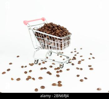 Chicchi di caffè all'interno del piccolo carrello su sfondo bianco Foto Stock