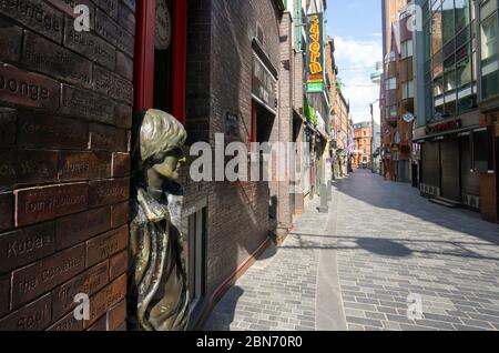 John Lennon statua su una vuota Mathew Street durante la pandemia blocco a Liverpool Foto Stock