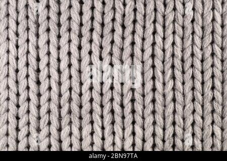 Maglieria. Primo piano di un frammento di maglia con un filo spesso. Foto Stock