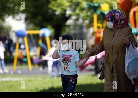 Ankara, Turchia. 13 maggio 2020. Un bambino che indossa una maschera facciale è visto in un parco giochi ad Ankara, Turchia, il 13 maggio 2020. I bambini di età inferiore ai 14 anni in Turchia sono stati ammessi all'esterno mercoledì per la prima volta in 40 giorni nell'ambito del piano di normalizzazione COVID-19 del paese. Il numero totale di casi COVID-19 in Turchia è salito a 143,114, mentre il numero dei decessi è salito a 3,952 mercoledì. Credit: Mustafa Kaya/Xinhua/Alamy Live News Foto Stock