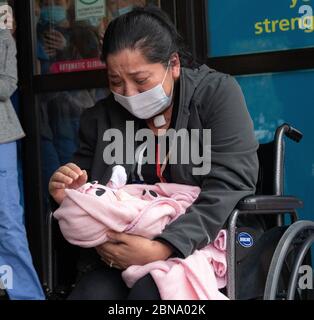 12 maggio 2020, Cambridge, Massachusetts USA: Isabel Gonzalez vede il suo bambino Victoria per la prima volta, quando è dimessa dal COVID-19 Recovery Unit Spaulding Hospital di Cambridge. Gonzalez, 34 anni da Chelsea, ma, incinta quando ha contratto il COVID-19, ha consegnato il suo bambino Victoria attraverso la sezione C di emergenza al Massachusts General Hospital il 30 marzo, quando è stata inizialmente ammessa. È stata trasferita in UTI il 2 aprile, intubata e ha avuto un ventilatore fino al 26 aprile. È stata ammessa allo Spaulding Hospital Cambridge il 4 maggio ed ora ha testato COVID negativo a Foto Stock