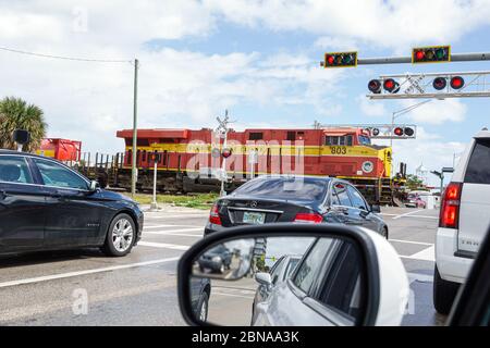 Miami Florida, ferrovia che attraversa i cancelli giù che passa il treno, veicoli a traffico fermato auto in attesa, East Coast Railway, locomotiva rossa, visitatori viaggio trave Foto Stock