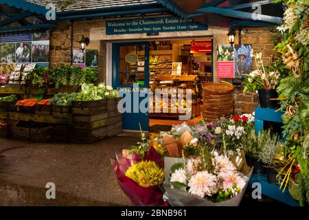 Regno Unito, Inghilterra, Derbyshire, Pilsley, Chatsworth Estate Farm negozio in ex Stud Farm edifici, fiori e bancarelle di verdure all'ingresso Foto Stock