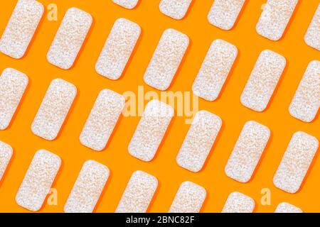Modello fatto di cracker di riso o torte di riso su sfondo di colore arancione. Cibo biologico sano. Disposizione piatta. Foto Stock