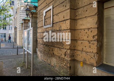 Fori di proiettile sulla facciata dell'edificio nel centro di Berlino della seconda guerra mondiale Foto Stock