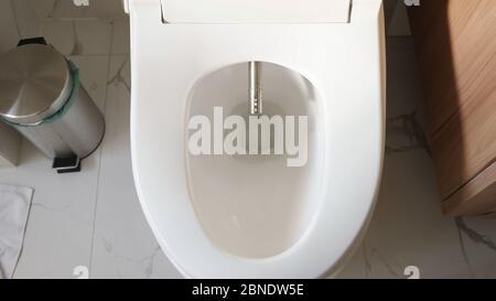 moderno iniettore di bidet argento appare in bianco a filo vicino spazzatura bidone smart casa bagno vicino vista superiore Foto Stock