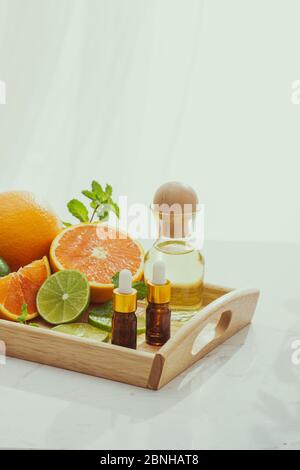 Organici cosmetici con estratti di erbe di limone, arancio, menta su sfondo lucido Foto Stock