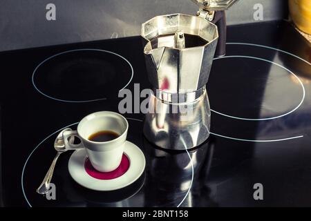 macchina per il caffè e tazza di caffè nero pronti per la colazione e per iniziare la giornata Foto Stock