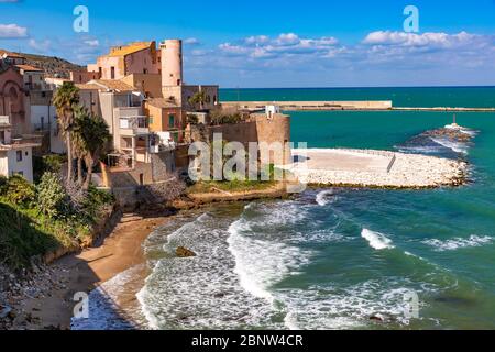 Spiaggia soleggiata Cala Petrolo, mare Mediterraneo e fortezza medievale a Cala Marina, porto nella città costiera Castellammare del Golfo, Sicilia, Italia Foto Stock