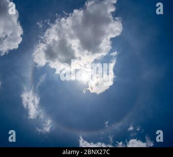 Foto di un alone solare visibile nel cielo. Un cerchio di colore con il sole al centro e alcune nuvole di circo intorno ad esso Foto Stock