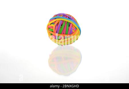 Una colorata sfera di fasce elastiche isolate su uno sfondo bianco con un riflesso. Foto Stock