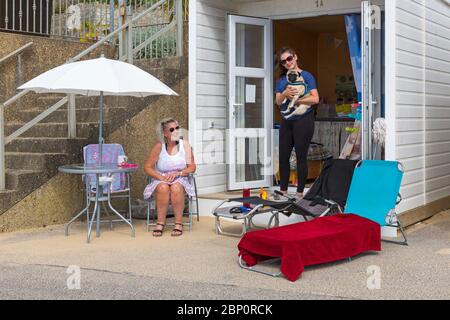 Poole, Dorset UK. 17 maggio 2020. Meteo per il Regno Unito: Calde e soleggiate alle spiagge di Poole, mentre i beachgoers si dirigono verso il mare per godersi il sole il primo fine settimana dopo i cambiamenti per alleviare le restrizioni di Coronavirus che le persone possono sedersi o prendere il sole sulla spiaggia quanto desiderano, purché aderiscano alle distanze sociali. Albert il pug gode di vita al mare. Credit: Carolyn Jenkins/Alamy Live News Foto Stock