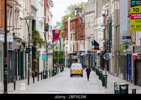 Pedoni su Grafton Street deserta nel centro di Dublino, mentre la caduta dei piedi precipita a causa della pandemia di coronavirus. Covid-19 in Irlanda. Foto Stock