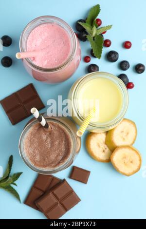 Deliziosi milkshake su sfondo blu. Drink estivo Foto Stock