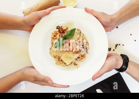 Pasta di pesce e formaggio su sfondo chiaro. Deliziosi spaghetti con pesce e formaggio Foto Stock