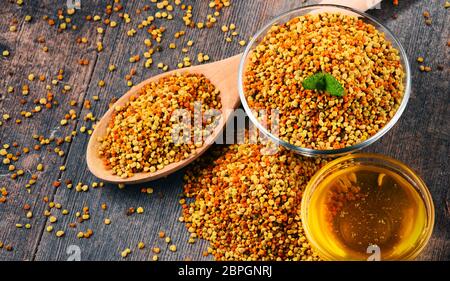 Bocce con bee di polline e di miele sul tavolo da cucina. Integratori alimentari Foto Stock