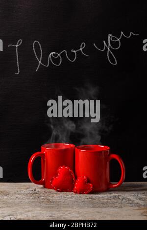 Amore, caffè e romanticismo concetto. Coppia di vaschette con un gesso testo ti amo Foto Stock