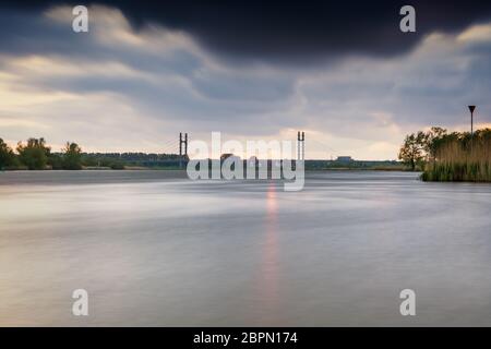 Ponte con cavi su un fiume olandese vicino alla città di Kampen Overijssel con un tramonto nuvoloso Foto Stock