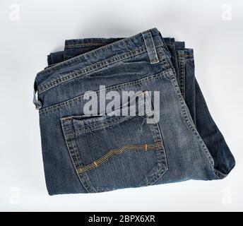 Ripiegate blue jeans da uomo su uno sfondo bianco, vista dall'alto Foto Stock