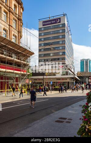 Vista lungo Corportation Street, piena di negozi e visitatori, verso la torre Premier Inn, Birmingham, Regno Unito Foto Stock