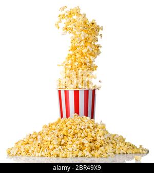 Popcorn volanti da bucket a strisce di carta e popcorn sparsi isolati su bianco Foto Stock