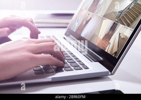 Close-up di un imprenditore il monitoraggio a mano telecamera TVCC filmati sul computer portatile Foto Stock