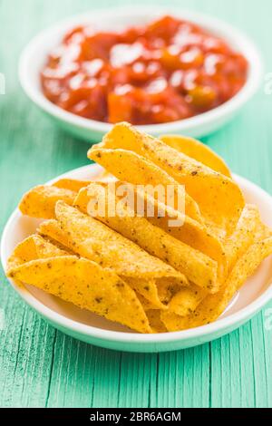 Laminati Messicano nacho patatine e salsa dip sul tavolo verde. Foto Stock