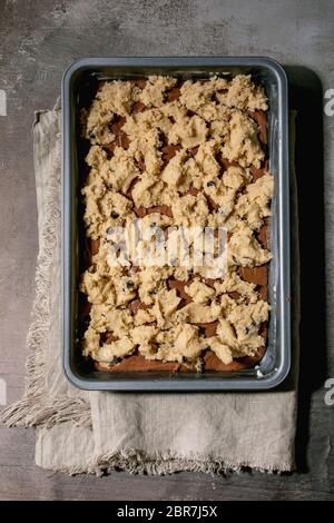 Pronti a cuocere i tipi di pasta di cioccolato e shortbread per la cottura a casa tendenza dessert brownie e biscotti in vassoio da forno su tela di lino ov Foto Stock