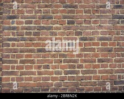 Rosso scuro muro di mattoni utili come uno sfondo Foto Stock