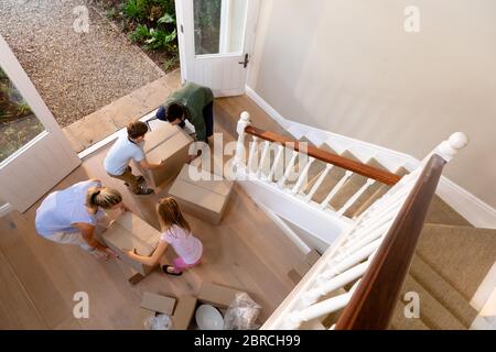 Coppia caucasica e i loro figli che arrivano alla loro nuova casa Foto Stock