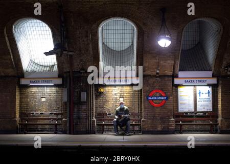 Un uomo che indossa una maschera facciale nella stazione della metropolitana di Baker Street a Londra il giorno di Sherlock Holmes, dopo l'introduzione di misure per portare il paese fuori dalla chiusura. Foto Stock