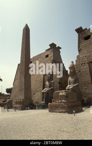 Colossali statue sedute di Ramses II accanto al pilone, Obelisco nel Tempio di Luxor, Egitto, Africa Foto Stock