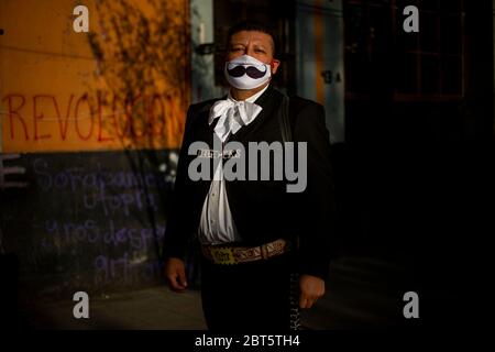 Mexiko Stadt, Messico. 16 maggio 2020. Jose Fuentes, conosciuto come 'El bigotes' (i baffi), si pone vicino a Plaza Garibaldi e indossa un boccaglio con una stampa baffi. La mariachia del Messico è in difficoltà perché le misure anticorona li privano della loro sussistenza. (A dpa 'Serenade Against Donation: Mariachis in Mexico chiedere 'scue') credito: Jair Cabrera Torres//dpa/Alamy Live News Foto Stock