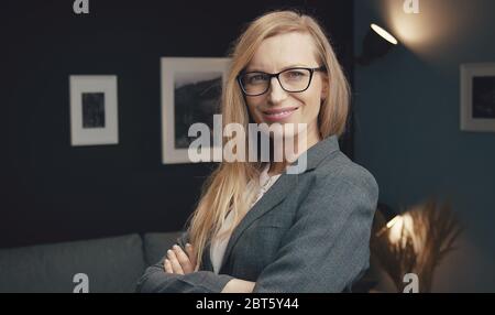 Imprenditrice sorridente con bracci incrociati Foto Stock
